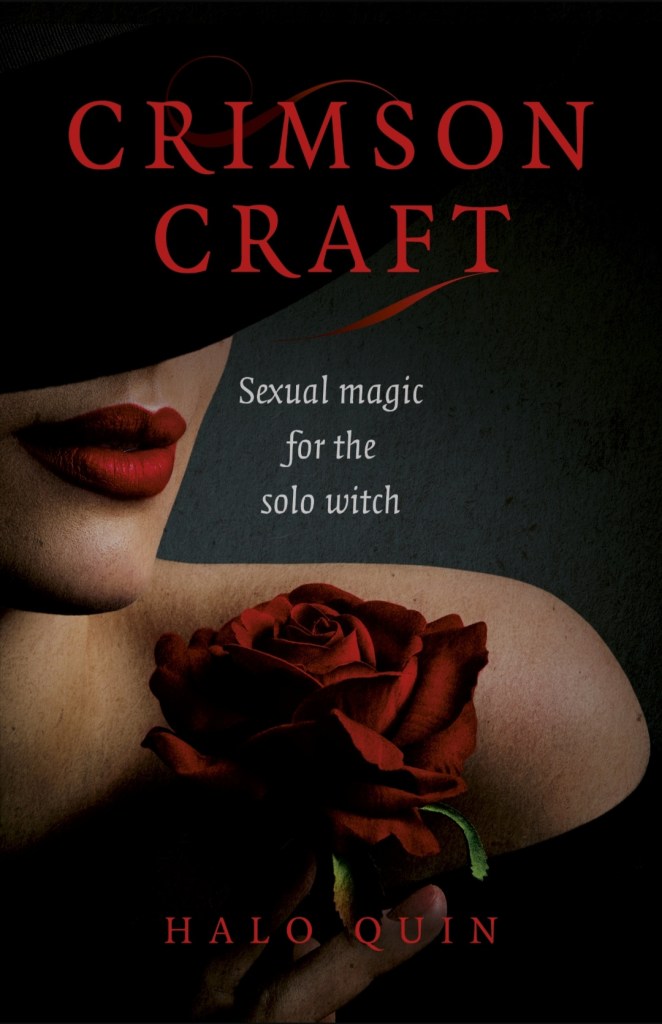 Cover of book, "Crimson Craft - Sexual Magic for the solo witch" by Halo Quin. Dark cover with a femme figure, shoulders up, holding a red rose with red lipstick highlighting a subtle smile, eyes hidden under a wide-brimmed black hat.